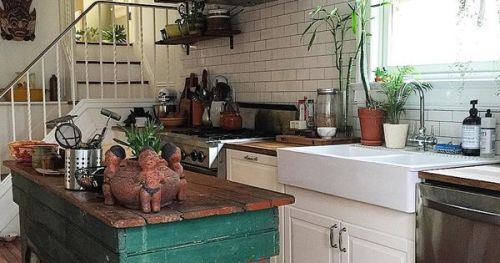 #BagoesTeakFurniture Classic white kitchen gets a pop of color with green island, bright rug, and op