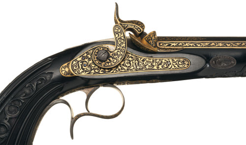 Magnificent cased, gold inlaid, and engraved pair of percussion dueling pistols by Prelat of Paris, 
