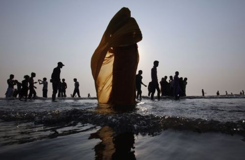 o-g-steve:awkwardsituationist:indian hindu devotees offer prayers to the sun in the arabian sea duri