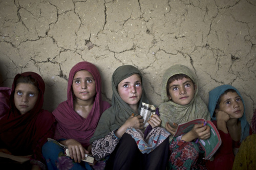 Afghan refugee girls listen to their teacher at a mosque on the outskirts of Islamabad, Pakistan on&