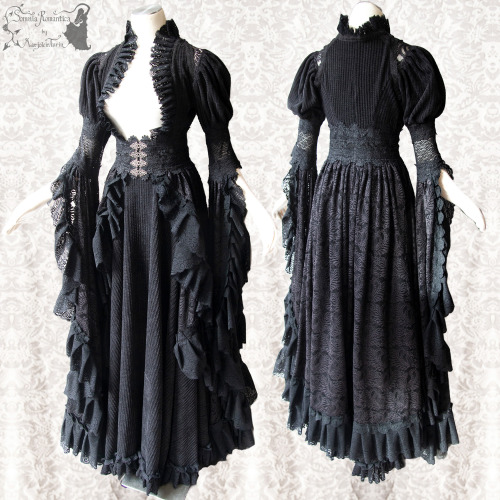 Black gown of a thick, structured winter fabric, combined with loads of laces and a belt of sturdy l