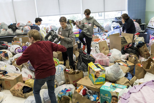 Needham residents gather donations for Cradles to Crayons at Needham High School on April 7, 2018.