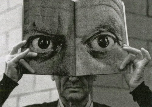 hauntedbystorytelling:   Ingeborg Morath :: Charles Eames posing with a Book ‘Mask’ of Picasso’s Eyes, 1959     more [+] by this photographer    