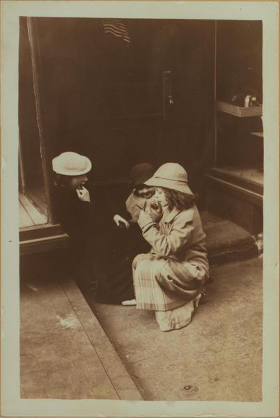  A little girl applying lipstick, at 367 Hdson Street, west side, between King and West Houston Stre