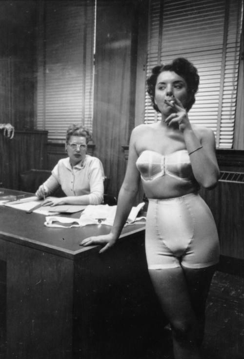 Stanley Kubrick - In Chicago, a lingerie model takes a smoke break while behind the scenes at a fashion show. Nudes & Noises  