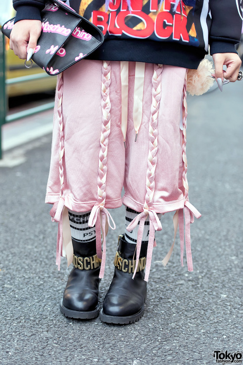 Shoushi on the street in Harajuku wearing a DVMVGE sweatshirt with Nicopanda pants, Moschino boots, 