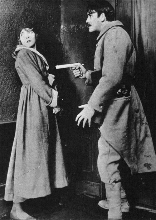 Death before dishonor. Robert Harron prepares to shoot his sweetheart, Lillian Gish, rather than all