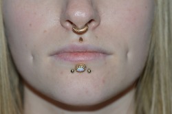 piratepiercing:  Our pretty resident tattooist Maartje and her new pieces from Bvla : a simple yet stunning 14k gold teardrop for the medusa and an outstanding 14k gold oval crown cab with white synthetic opal for her center labret.