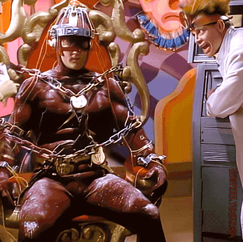 heroperil:  The Flash (1990) “The Trial of The Trickster”   (Flash Brainwashed by Trickster)Season 1, Episode 21After being knocked out by The Trickster, The Flash wakes up to find himself restrained in an electrical / optical brainwashing device.