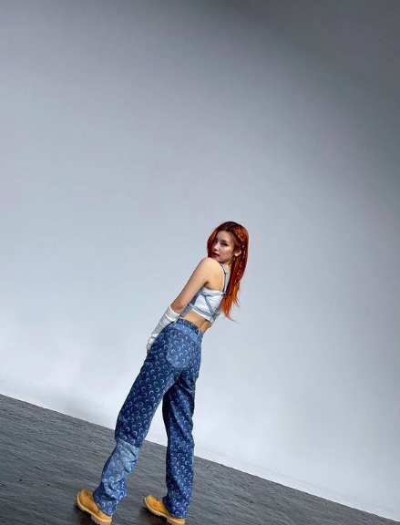 Itzy’s Yeji wearing MARINE SERRE denim vest $705 AUD and blue regenerated allover moon jeans $1,515 