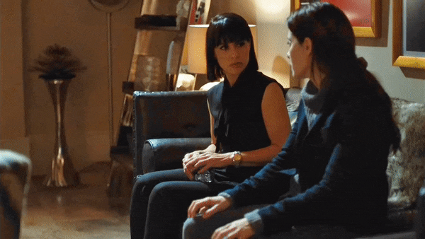 Rachel lying down in Quinn's lap, Quinn looks unsure of what to do