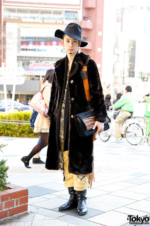 Tokyo vintage boutique employee wearing a vintage fur coat with a resale hat, resale leather boots, 