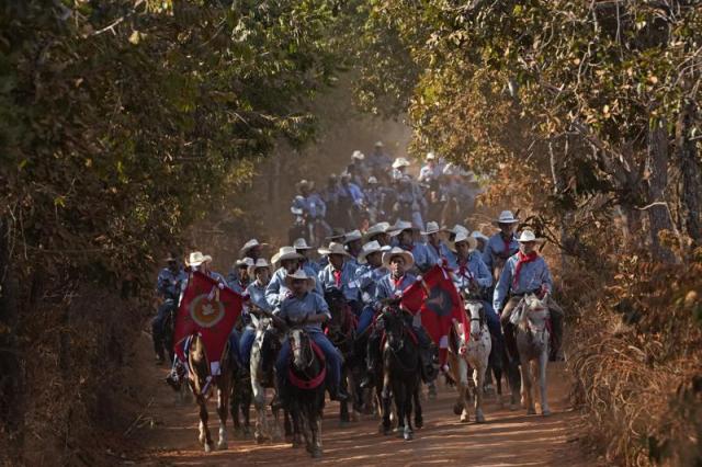 Mounted revelers parade in the culmination of the religious tradition, "Folia do Divino Espirito Santo" or Feast of the Divine, in the rural area of Pirenopolis, state of Goias, Brazil, Saturday, May 28, 2022. 