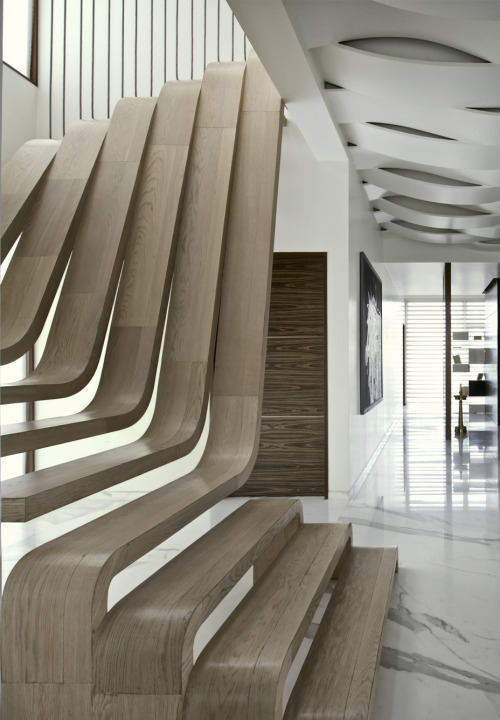{The centerpiece of this apartment by Arquitectura En Movimiento Workshop is the staircase, a striki