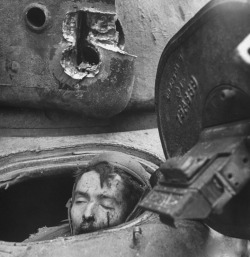 enrique262:  Dead crew member of a destroyed Sherman tank.