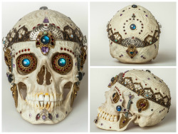 dappledwithshadow:  A real human skull carved and ornamented with 170 gemstones, including Pink Tourmaline, Welo Ethopian Opal, Almandine Garnet, Rhodolite, African Amethyst, Brazilian Amethyst, Swiss Blue Topaz, Labradorite, Spinel, brass and silver.