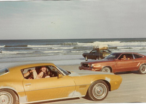 elektrotacker:  funnster:  Cruising Daytona Beach, 1980s.  It seems like there’s more going here than cruising…the one in the background is headed for Europe, sea trip! 