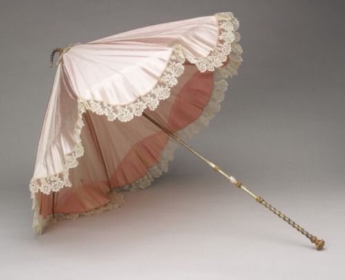 thequeenvictoriafiles: Beautiful pink silk and Honiton lace parasol, featuring an enamel hand wearin