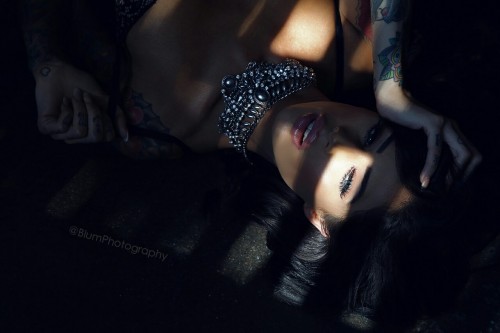 Tattooed beauty, Lisa Marie, playing on the floor.