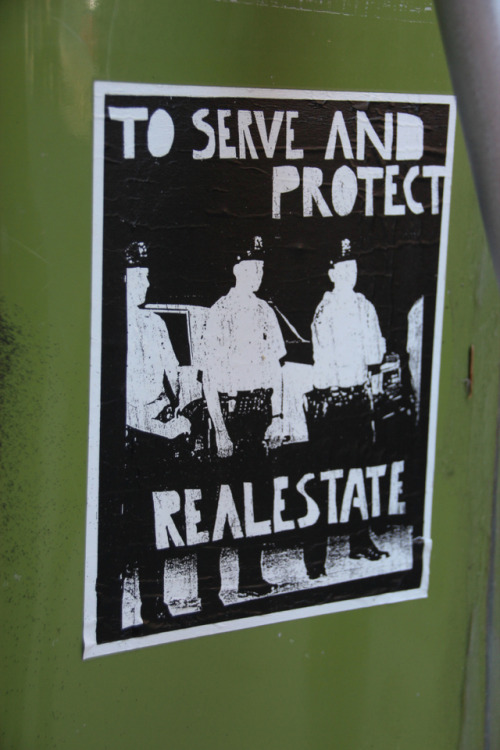 “To serve and protect real estate”Anti-Cop sticker in NYC