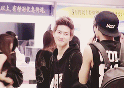 jongins:  suho messing around with kai’s bandana and taking photos of him 