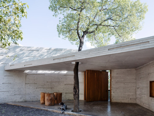 archatlas:  Ventura House in MonterreyThis house by Mexican architect Tatiana Bilbao comprises a cluster of five-sided concrete blocks that emerge from a forested hillside to offer panoramic views towards the city of Monterrey. The uneven terrain informed