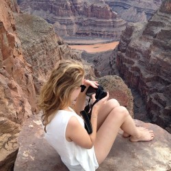 looking through her photos on the edge of the cliff&hellip; (at Grand Canyon West Rim)