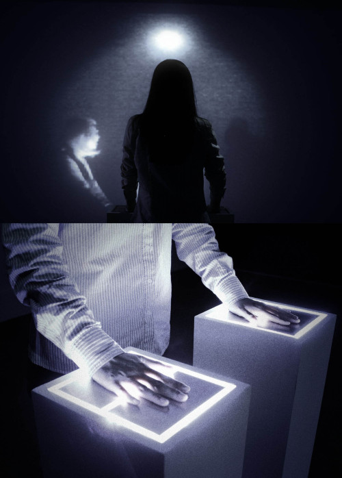 the-blue-room:  Grégory Chatonsky, Intrus-Intruders, 2013 The viewer enters a dark room. He puts his hand on a luminous surface that detects the heartbeat. At each beat, a ghostly face appears in front of him to disappear gradually. It is the spectators