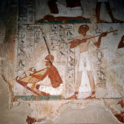 A detail of a wall painting in the tomb of Rekhmire showing musicians playing the harp and the lute.