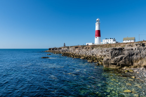 Portland Bill Lighthouse by George Plakides The distinctive red and white tower first shone its famo