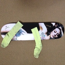 Me on a skateboard deck, censored by socks.