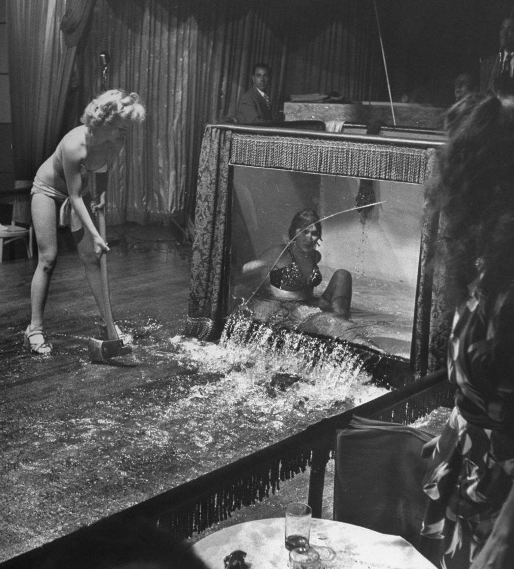historicaltimes:  Stripper Evangeline Sylvas angrily breaking the water tank being