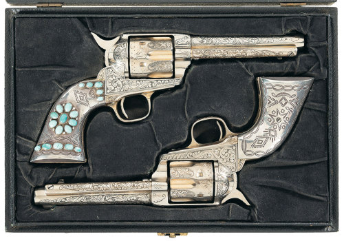 A cased and engraved pair of silver plated, turquoise mounted Colt M1873 single action revolvers. In