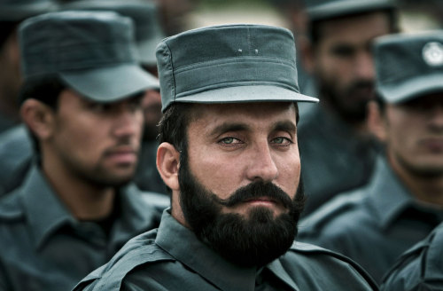 Newly-graduated Afghan police officers attend their graduation ceremony at a National Police trainin