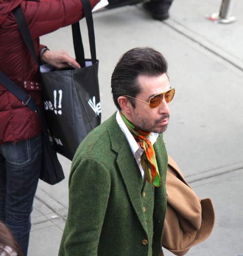 Everything: green tweed suit, camel overcoat, orange highlights on the bandana and brown shades to top it off…