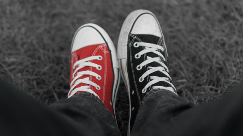 mismatched converse sneakers on legs