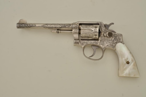 An engraved Smith and Wesson Police Model .38 revolver with carved pearl grips, early 20th century.