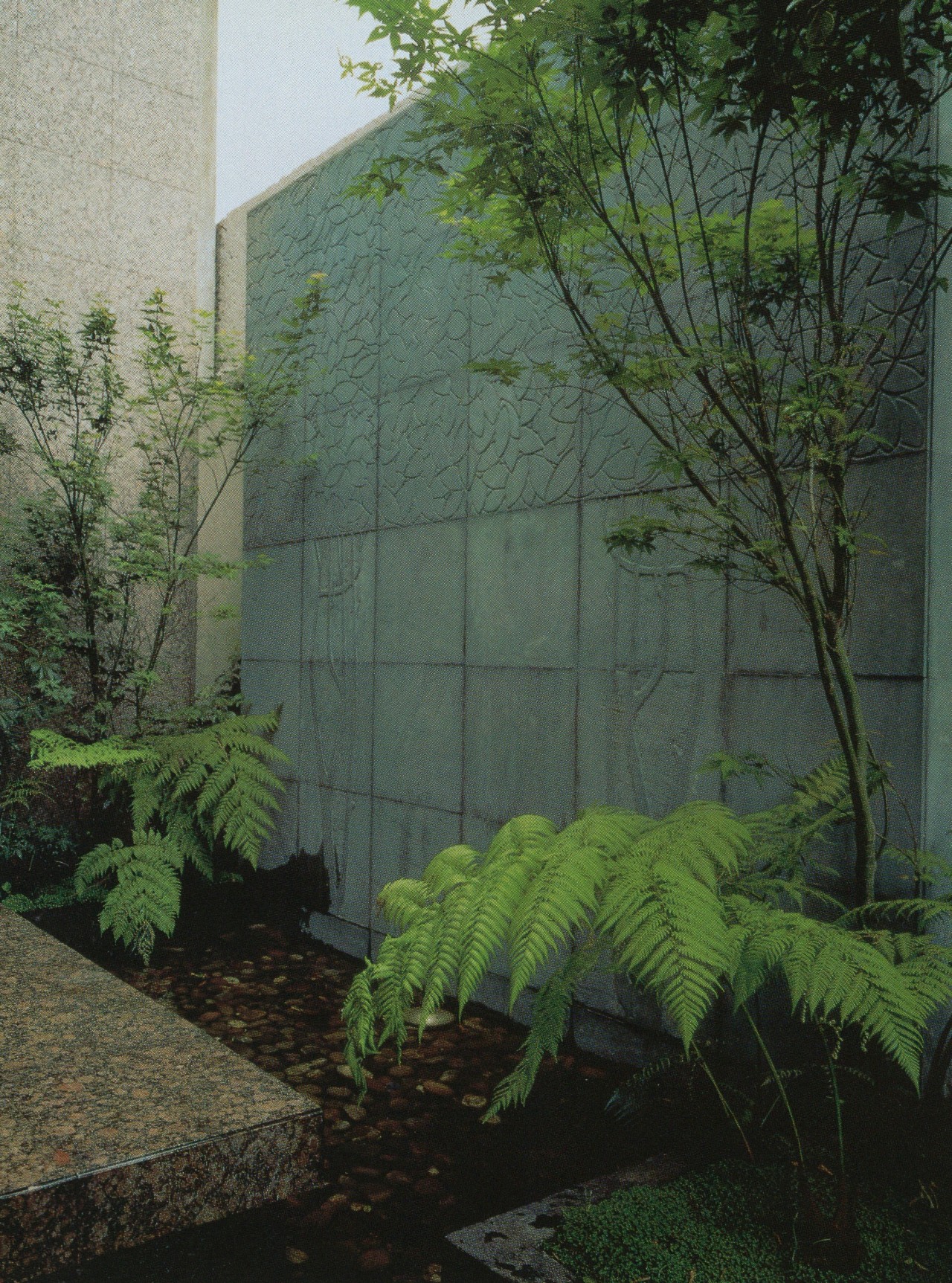 Standing out in relief against a facade of Huixquilucan stone are a fountain and its surrounding paving of recinto (volcanic) stone.Designing with Tile, Stone & Brick, 1995 #vintage#vintage interior#1990s#interior design#home decor#fountain#outdoor living#stone#volcanic#ferns#trees#pool#granite#contemporary#style#home#architecture
