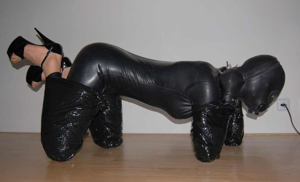 3-holes-2-tits:  Another bitchsuit-style training.Her hands are properly sealed in