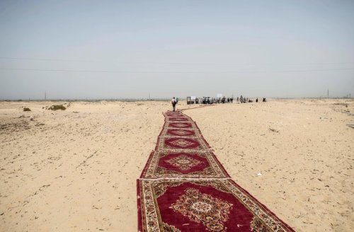 aradeia:Near Minya, Egypt. Carpets line the way to a newly discovered tomb of mummies dating to the 