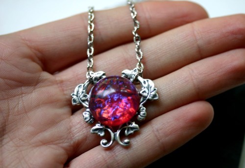 wickedclothes: Dragon’s Breath Fire Opal Necklace Sitting on top of a heart-shaped vine, this 