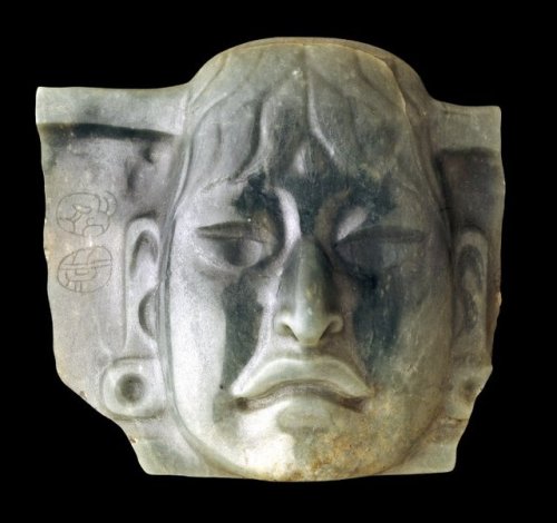 Jadeite ornamental breastplate in the form of a human face (Olmec).It was reused (as an heirloom?) b