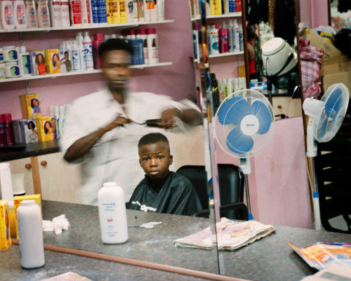 20aliens: GREECE. 2003. Nigerian barbershop.Jim Goldberg