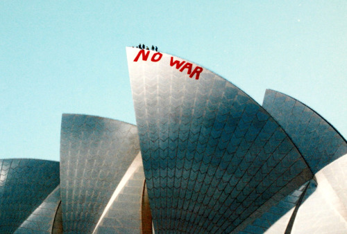 germanpostwarmodern:On March 18, 2003, Jørn Utzon’s Sydney Opera House (1959-73 ) was climbed by Will Saunders & David Burgess who wrote “No War” on one of its sails to protest the looming Iraq war.