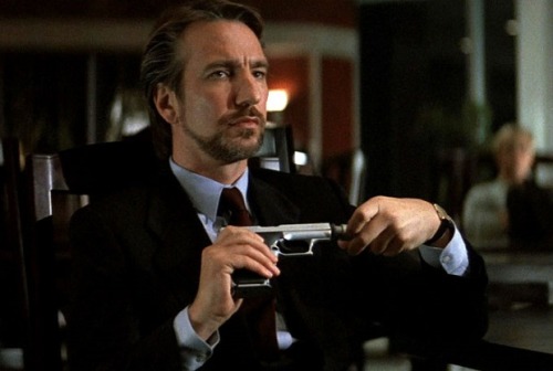 [ID: 1. A Picture Of Hans Gruber From Die Hard. He's Holding A Handgun And Looks Concentrated. 2. A Screenshot