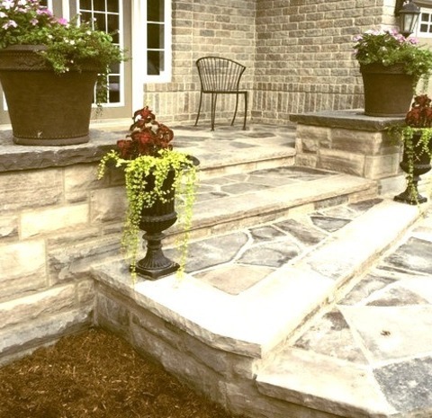 Toronto Traditional PorchAn Example Of A Mid-sized Traditional Stone Front Porch Design With A Roof Extension.
