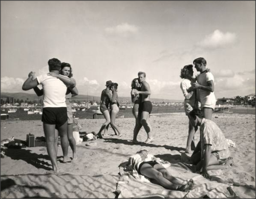 Junior College students dancing to music from a portable radio, 1947 Balboa Beach, California