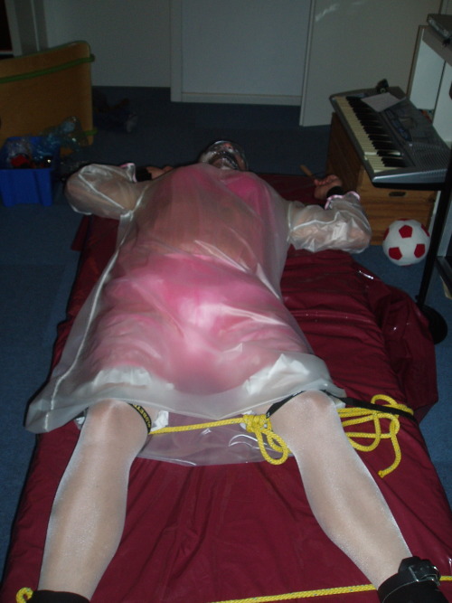 sissy is waiting for mistress to come back in several layers of pink and transparent pvc. of course,