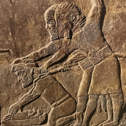 historyarchaeologyartefacts - Two Assyrian soldiers forcing...