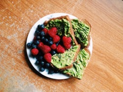 theblondeyogini:  Part of my brain-fueling breakfast. Blueberries and raspberries with whole grain toast with smashed avocado, red pepper flakes, and chia seeds 